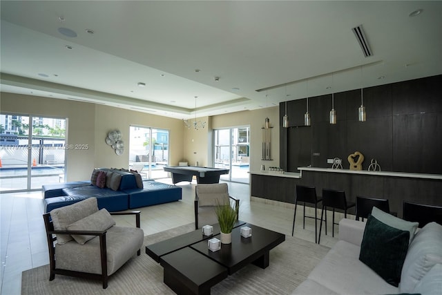 1010 SW 2nd Ave Unit 1703, Miami, FL 33130 - living area featuring a tray ceiling, plenty of natural light, and visible vents