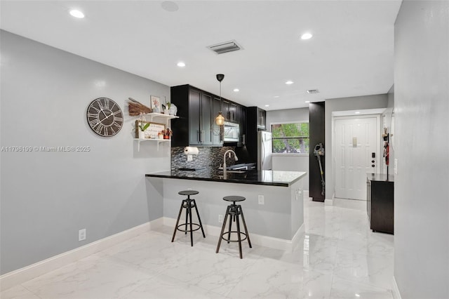kitchen featuring open shelves, stainless steel appliances, baseboards, and a sink