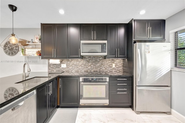 kitchen featuring backsplash, marble finish floor, appliances with stainless steel finishes, and a sink