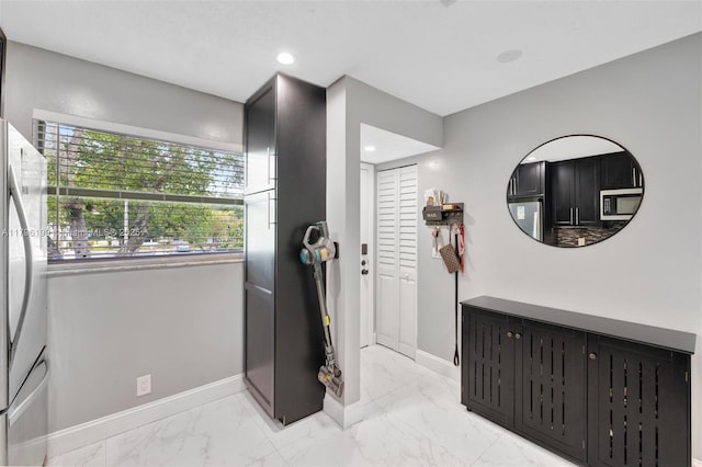 interior space with marble finish floor and baseboards