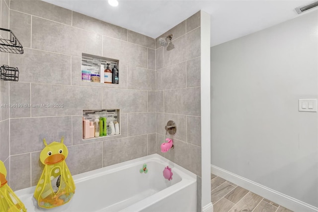 full bath with shower / bathing tub combination, wood finished floors, visible vents, recessed lighting, and baseboards