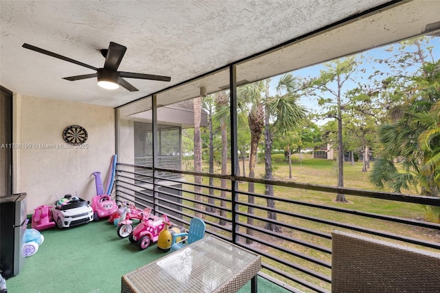 unfurnished sunroom with a ceiling fan