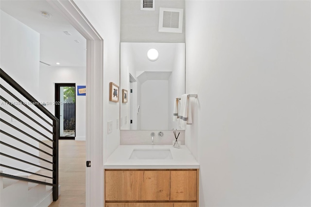 3132 Plaza St, Miami, FL 33133 - bathroom with wood finished floors, vanity, and recessed lighting