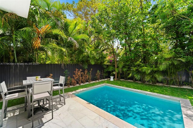 3132 Plaza St, Miami, FL 33133 - view of swimming pool featuring a patio, a fenced backyard, and outdoor dining space