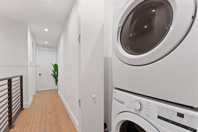 3132 Plaza St, Miami, FL 33133 - washroom featuring stacked washing machine and dryer, light wood-style floors, recessed lighting, and baseboards