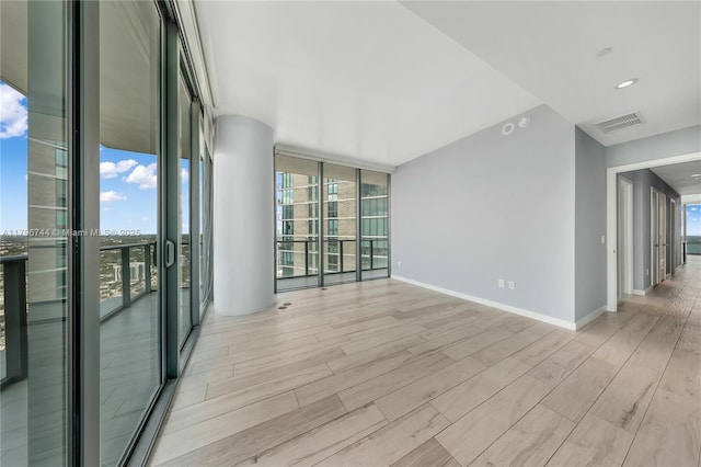 480 NE 31st St Unit 4307, Miami, FL 33137 - empty room with baseboards, light wood-style flooring, visible vents, and floor to ceiling windows