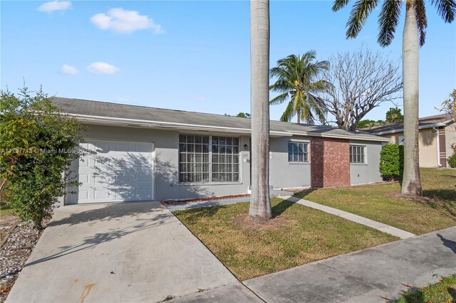 1732 N 16th Ave N, Lake Worth, FL 33460 - ranch-style home with an attached garage, stucco siding, driveway, and a front lawn