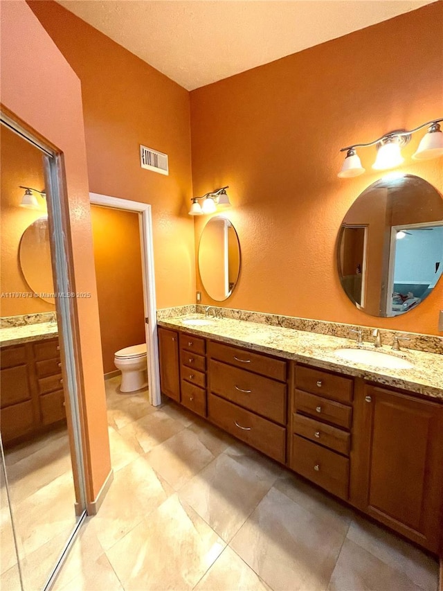 5400 NW Emblem St, Port St Lucie, FL 34983 - bathroom featuring double vanity and toilet