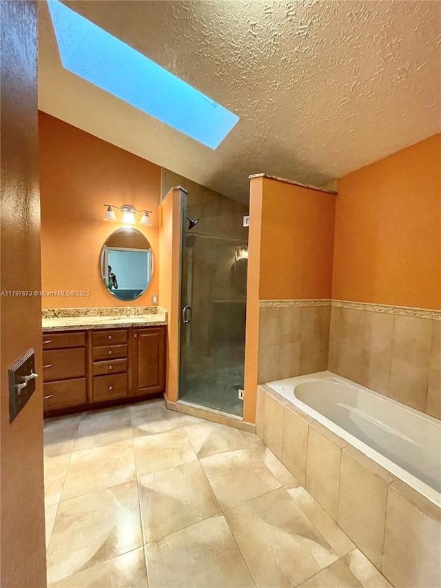 5400 NW Emblem St, Port St Lucie, FL 34983 - bathroom with a skylight, a stall shower, a garden tub, vanity, and a textured ceiling