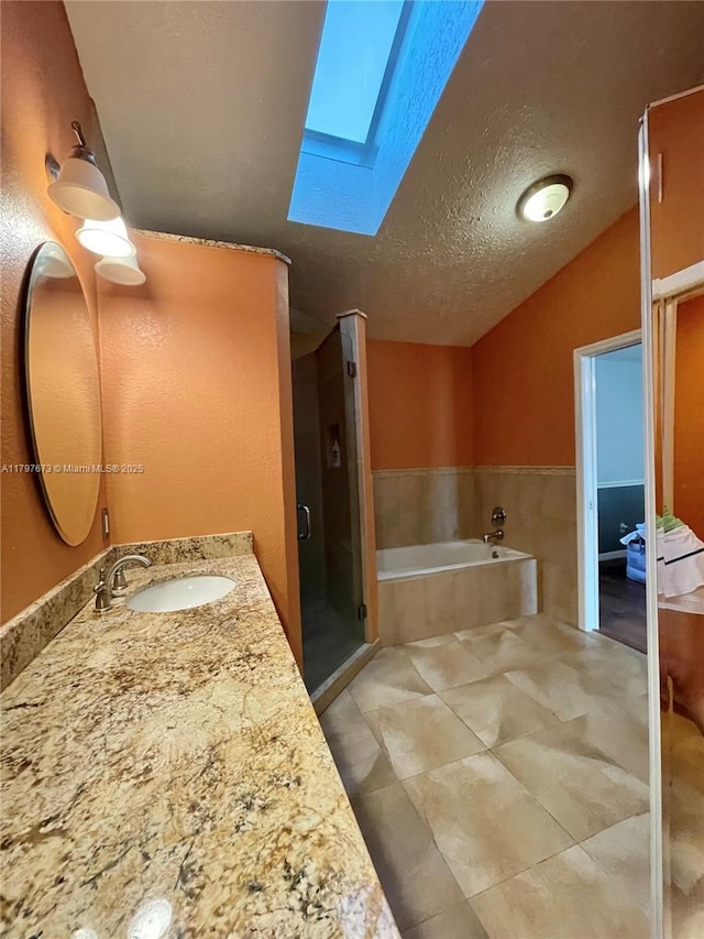 5400 NW Emblem St, Port St Lucie, FL 34983 - bathroom with a skylight, a stall shower, a garden tub, a textured ceiling, and vanity