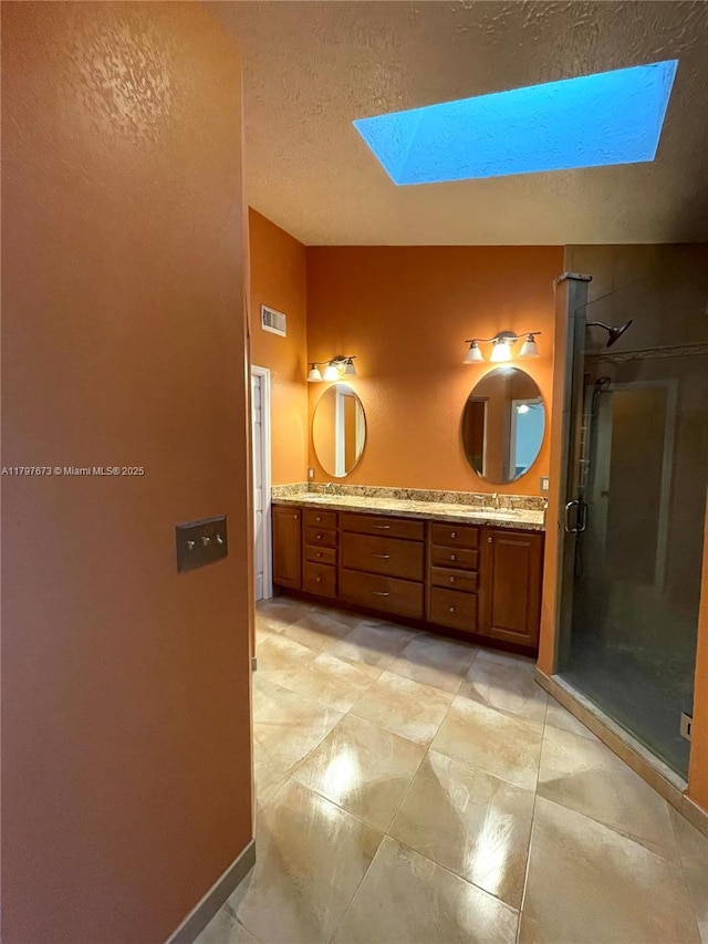 5400 NW Emblem St, Port St Lucie, FL 34983 - full bath featuring a skylight, a shower stall, double vanity, a textured ceiling, and baseboards