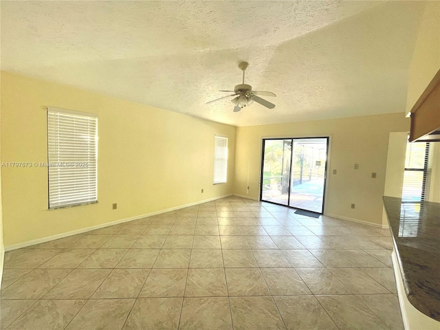 5400 NW Emblem St, Port St Lucie, FL 34983 - spare room featuring a textured ceiling, ceiling fan, light tile patterned floors, and baseboards