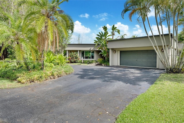 610 Lake Dasha Cir, Plantation, FL 33324 - view of front facade featuring asphalt driveway, a garage, and stucco siding