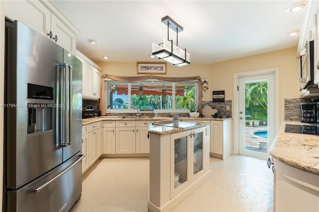 610 Lake Dasha Cir, Plantation, FL 33324 - kitchen with stainless steel appliances, decorative backsplash, light stone countertops, and recessed lighting