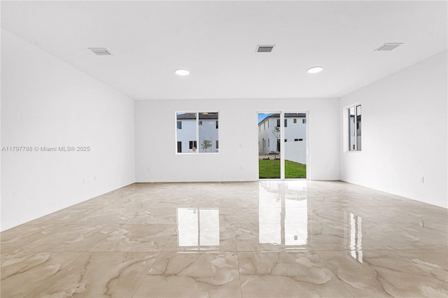 empty room featuring marble finish floor, recessed lighting, and visible vents