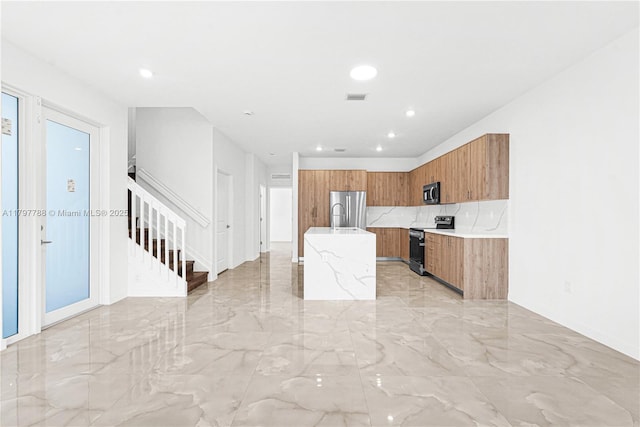 kitchen featuring brown cabinets, stainless steel appliances, visible vents, modern cabinets, and marble finish floor