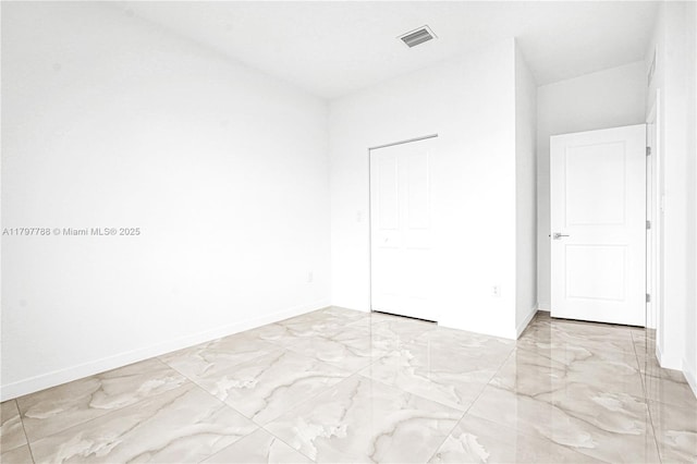 unfurnished bedroom featuring baseboards, marble finish floor, and visible vents