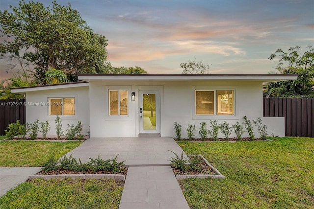10051 SW 48th St, Miami, FL 33165 - view of front facade featuring a yard, stucco siding, and fence