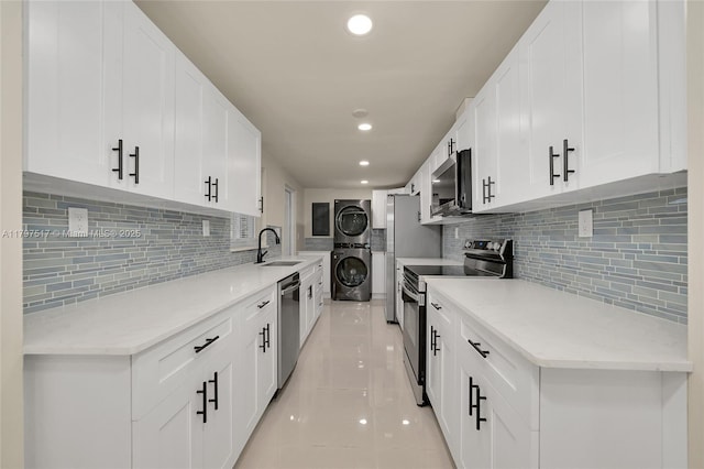 10051 SW 48th St, Miami, FL 33165 - kitchen featuring recessed lighting, stacked washer / dryer, light tile patterned floors, stainless steel appliances, and tasteful backsplash
