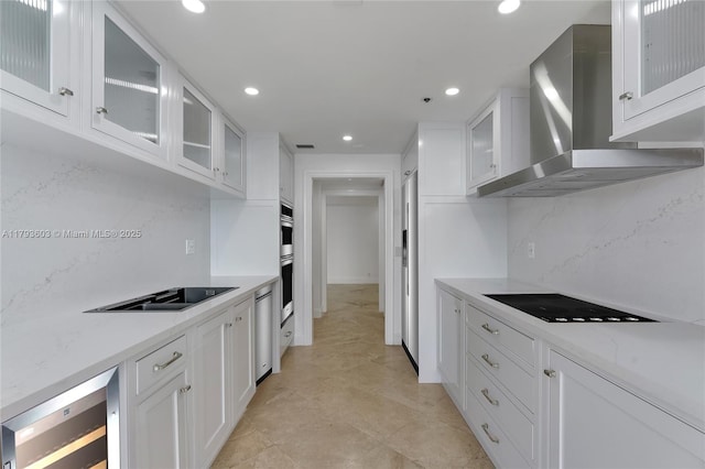 1581 Brickell Ave Unit Ph102, Miami, FL 33129 - kitchen featuring beverage cooler, wall chimney exhaust hood, white cabinetry, appliances with stainless steel finishes, and recessed lighting