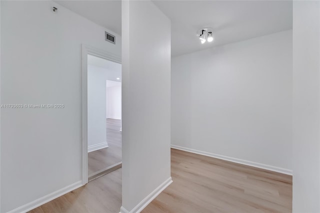 1581 Brickell Ave Unit Ph102, Miami, FL 33129 - hallway featuring baseboards, visible vents, and wood finished floors