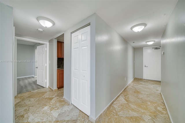 8888 Collins Ave Unit 201, Surfside, FL 33154 - corridor with stone finish floors and baseboards