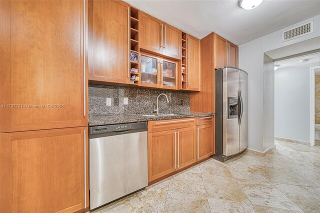 8888 Collins Ave Unit 201, Surfside, FL 33154 - kitchen with stainless steel appliances, a sink, open shelves, dark stone countertops, and decorative backsplash
