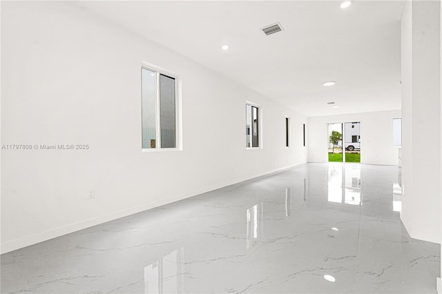 spare room featuring visible vents, marble finish floor, baseboards, and recessed lighting