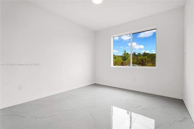 empty room with baseboards and marble finish floor