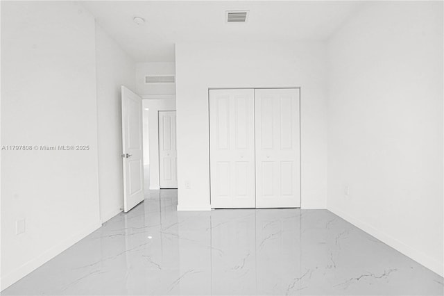 unfurnished bedroom with baseboards, marble finish floor, and visible vents
