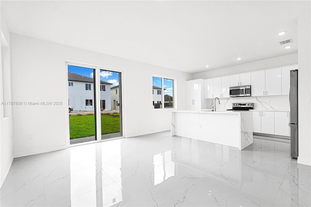 interior space with marble finish floor, visible vents, recessed lighting, and a sink