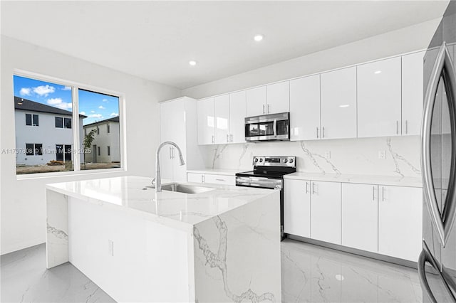 kitchen with a sink, appliances with stainless steel finishes, decorative backsplash, marble finish floor, and recessed lighting