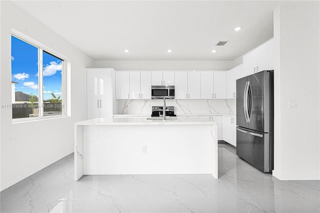 kitchen featuring stainless steel appliances, marble finish floor, visible vents, light countertops, and white cabinets