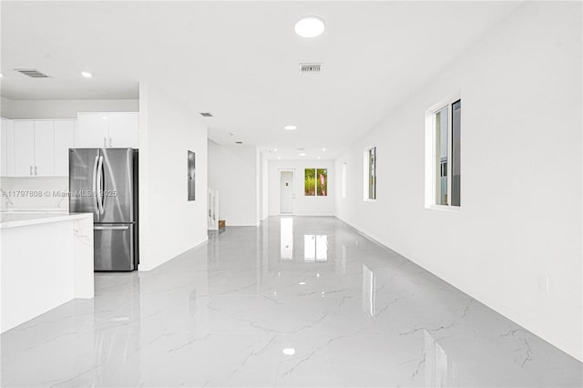 unfurnished room with visible vents, marble finish floor, and recessed lighting