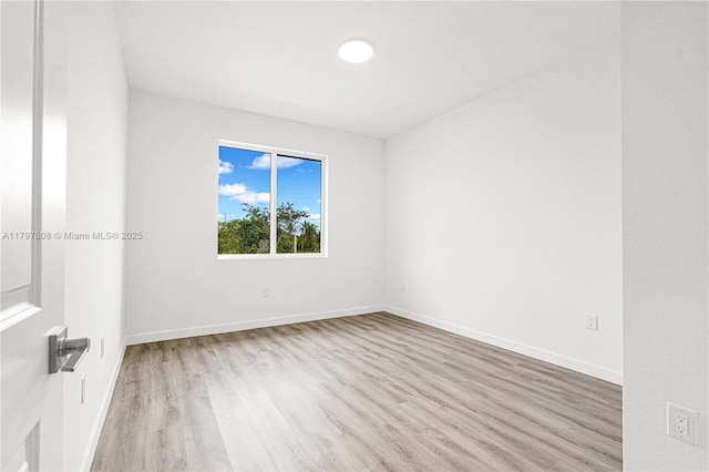 empty room featuring baseboards and wood finished floors