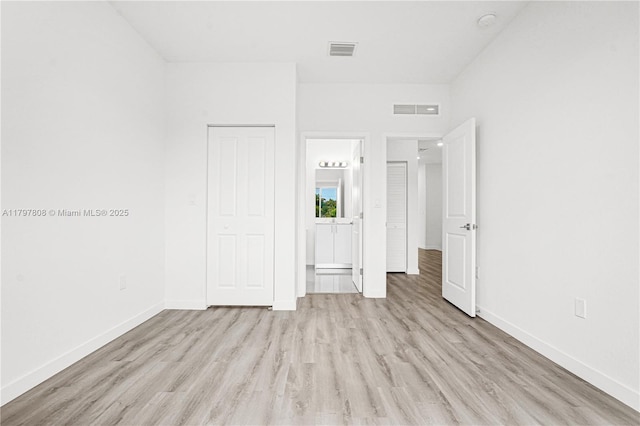 unfurnished bedroom featuring light wood-type flooring, visible vents, and baseboards