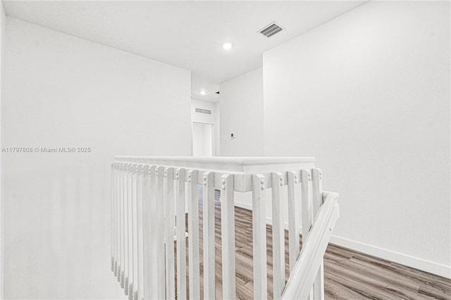 corridor with recessed lighting, baseboards, visible vents, and wood finished floors