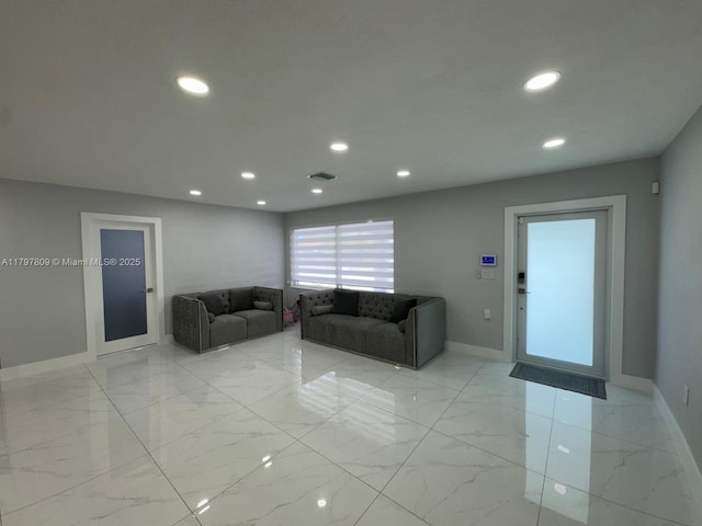 living area with marble finish floor, baseboards, visible vents, and recessed lighting
