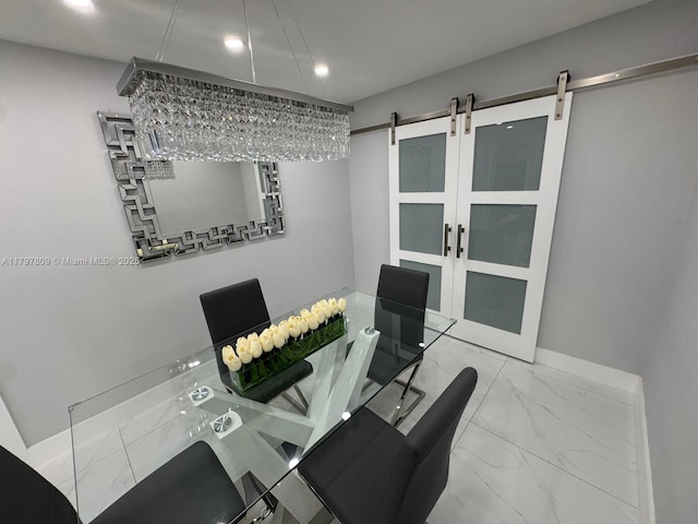 dining room with a barn door, marble finish floor, and recessed lighting