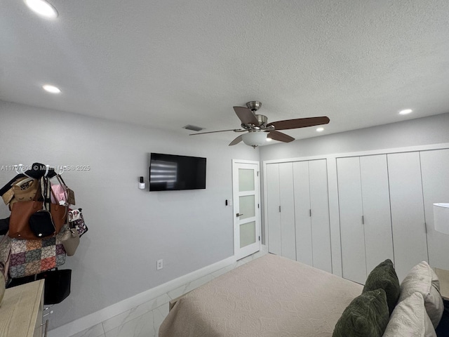 bedroom featuring two closets, baseboards, visible vents, and recessed lighting