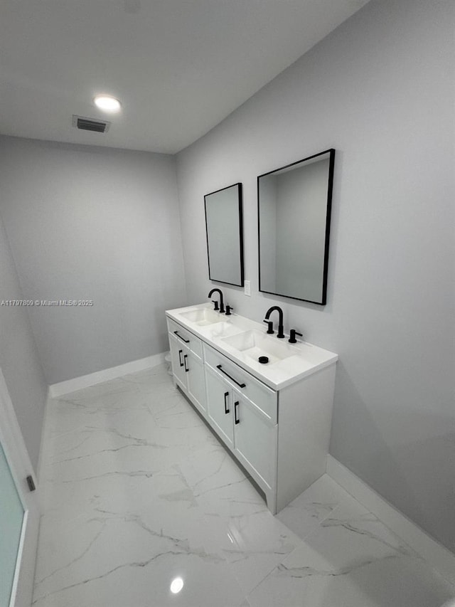 full bathroom with a sink, baseboards, and visible vents
