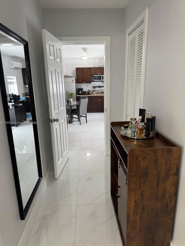 hallway with marble finish floor