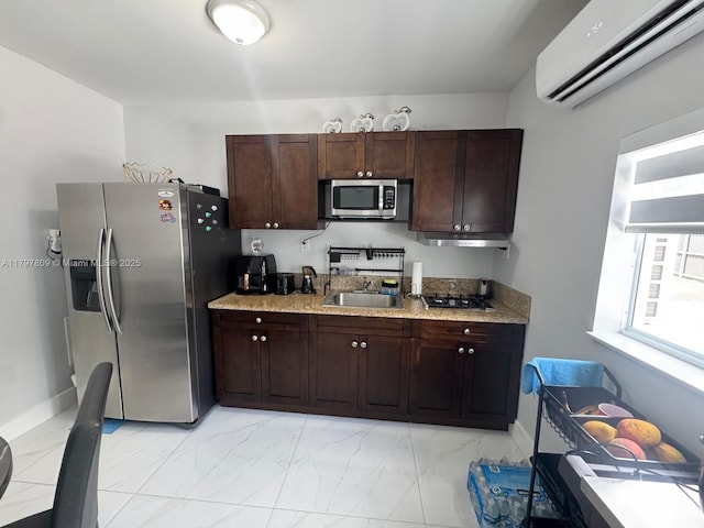 kitchen with marble finish floor, stainless steel appliances, a sink, and a wall mounted air conditioner