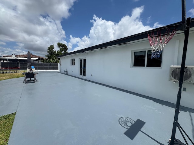 exterior space featuring a patio area, fence, and ac unit