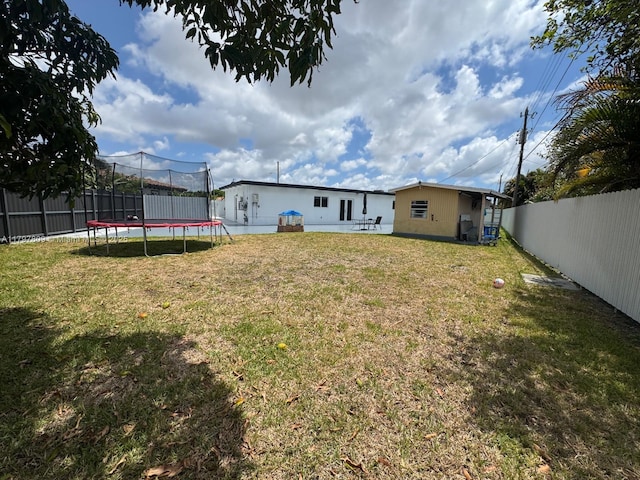 view of yard featuring a fenced backyard and a trampoline