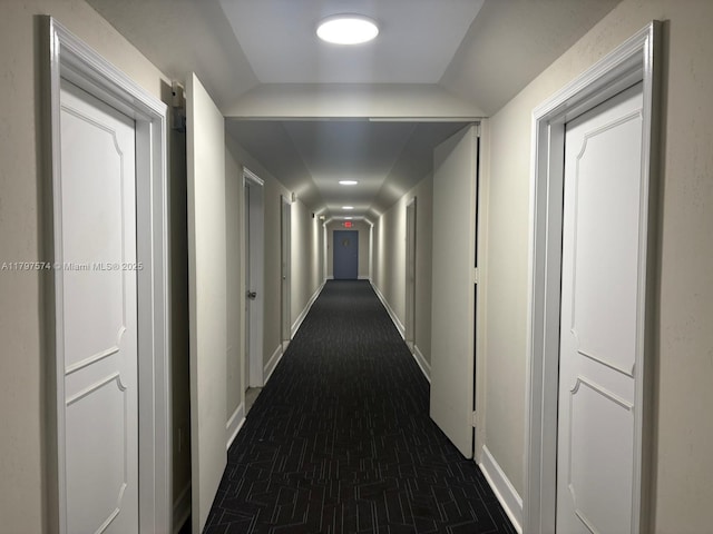 5838 Collins Ave Unit 10E, Miami Beach, FL 33140 - hall featuring baseboards, brick patterned floors, and lofted ceiling