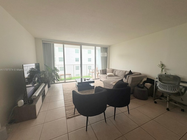 living room with floor to ceiling windows and light tile patterned flooring