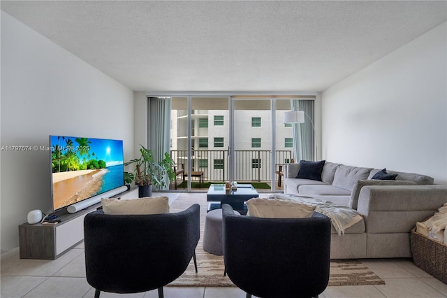 5838 Collins Ave Unit 10E, Miami Beach, FL 33140 - living room with light tile patterned flooring, plenty of natural light, a textured ceiling, and floor to ceiling windows