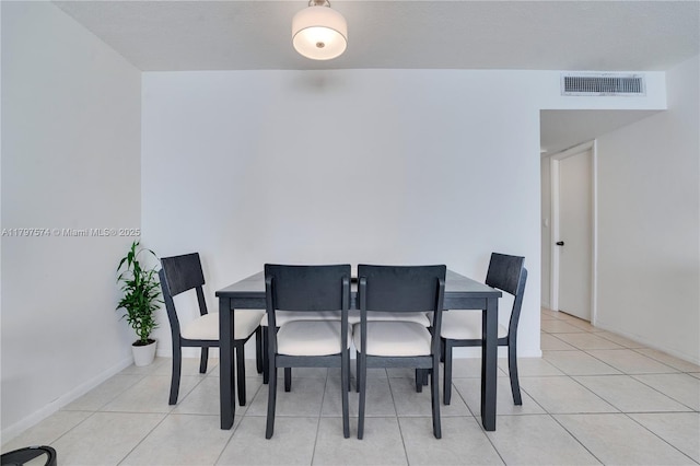 5838 Collins Ave Unit 10E, Miami Beach, FL 33140 - dining room with light tile patterned floors and baseboards