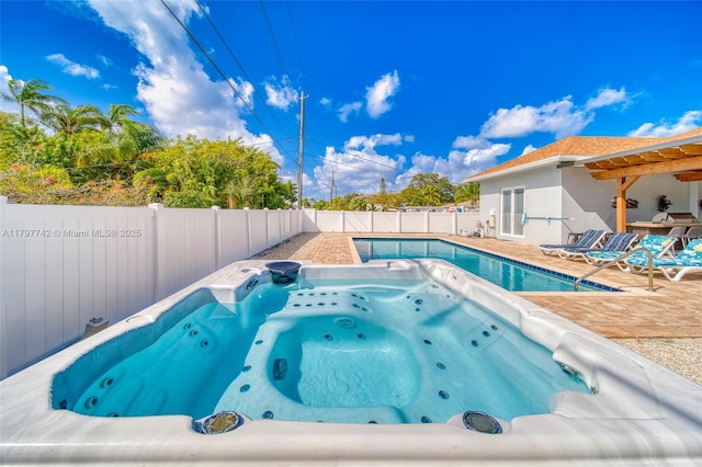 207 SW 11th St, Dania Beach, FL 33004 - view of pool featuring an outdoor hot tub, a fenced backyard, and a patio